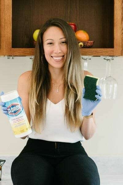 Alejandra, founder of Fresh Home Cleaning, holding cleaning supplies