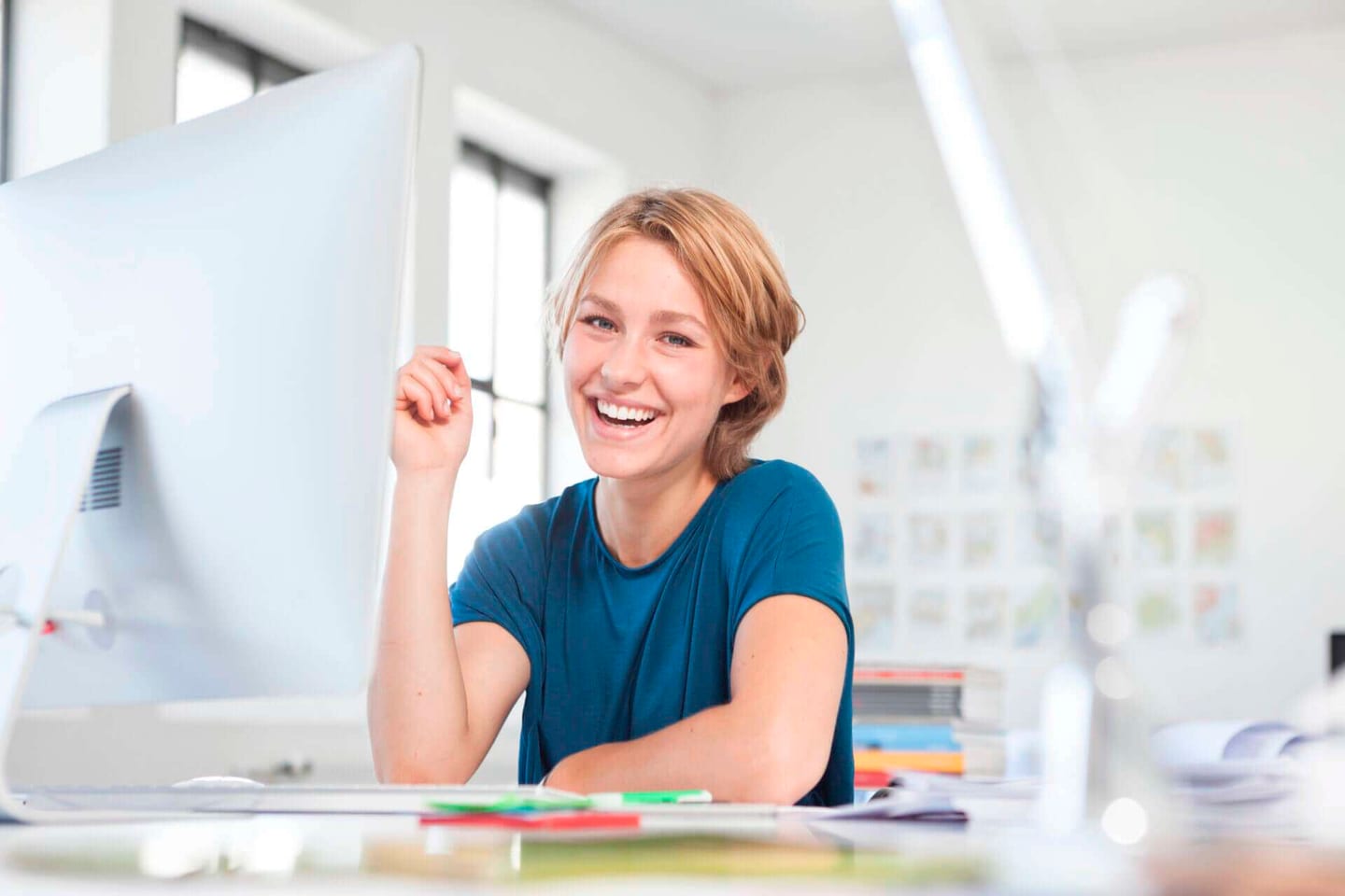 A woman smiling at her office desk
