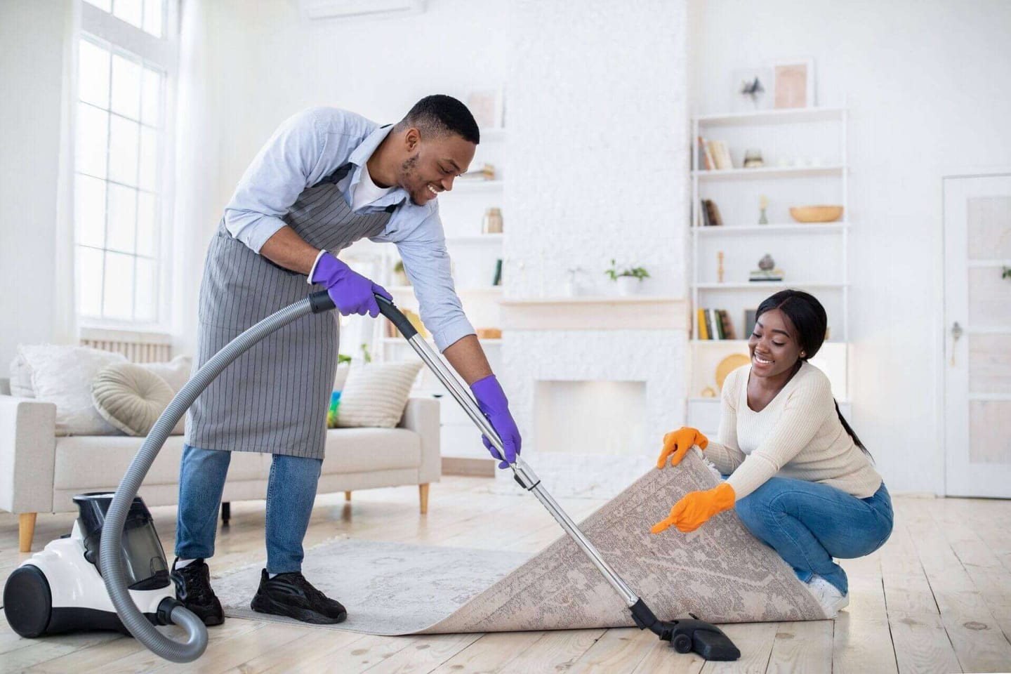 A person vacuuming their rug after learning how to keep carpet clean in high traffic areas