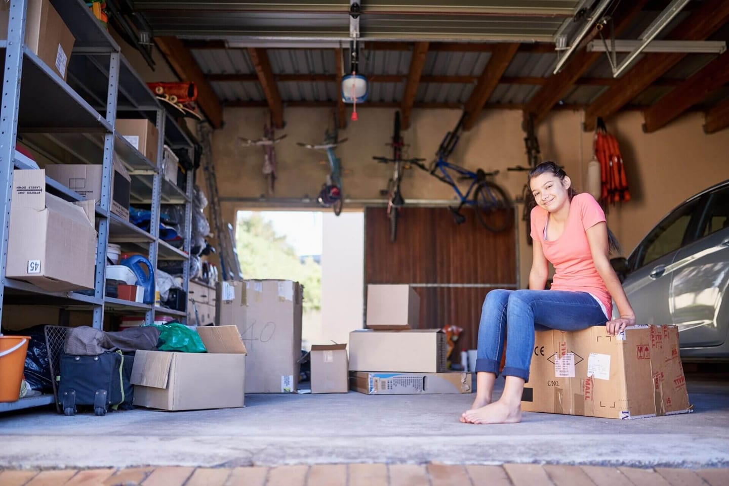 A person cleaning out the garage after learning how to clean garage walls