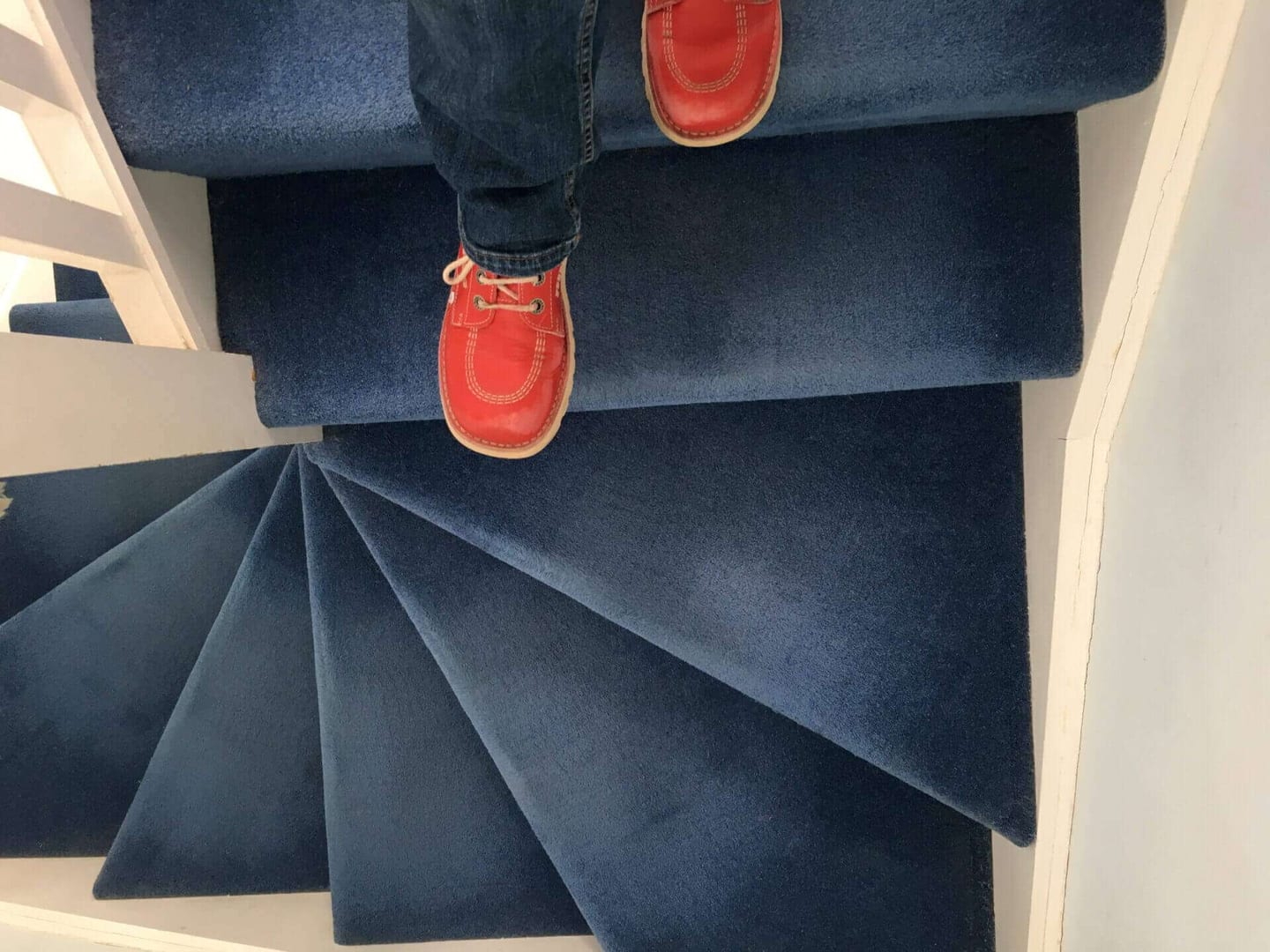Young man enjoying his house after learning how to clean carpet on stairs